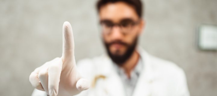 Doctor wearing medical gloves before a procedure