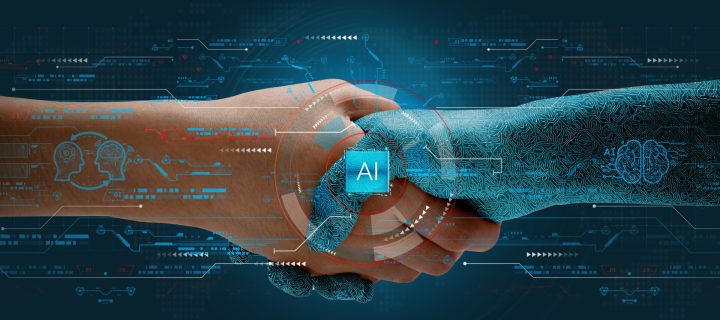 Humans shake hands with AI to show partnership. Machine learning to enable and work together to achieve greater innovation and success.